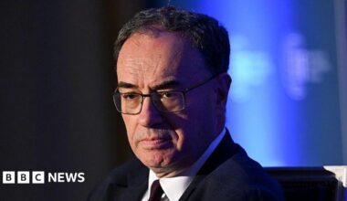 Andrew Bailey head and shoulders wearing a suit and tie with his eyes cast downwards and a serious expression on his face