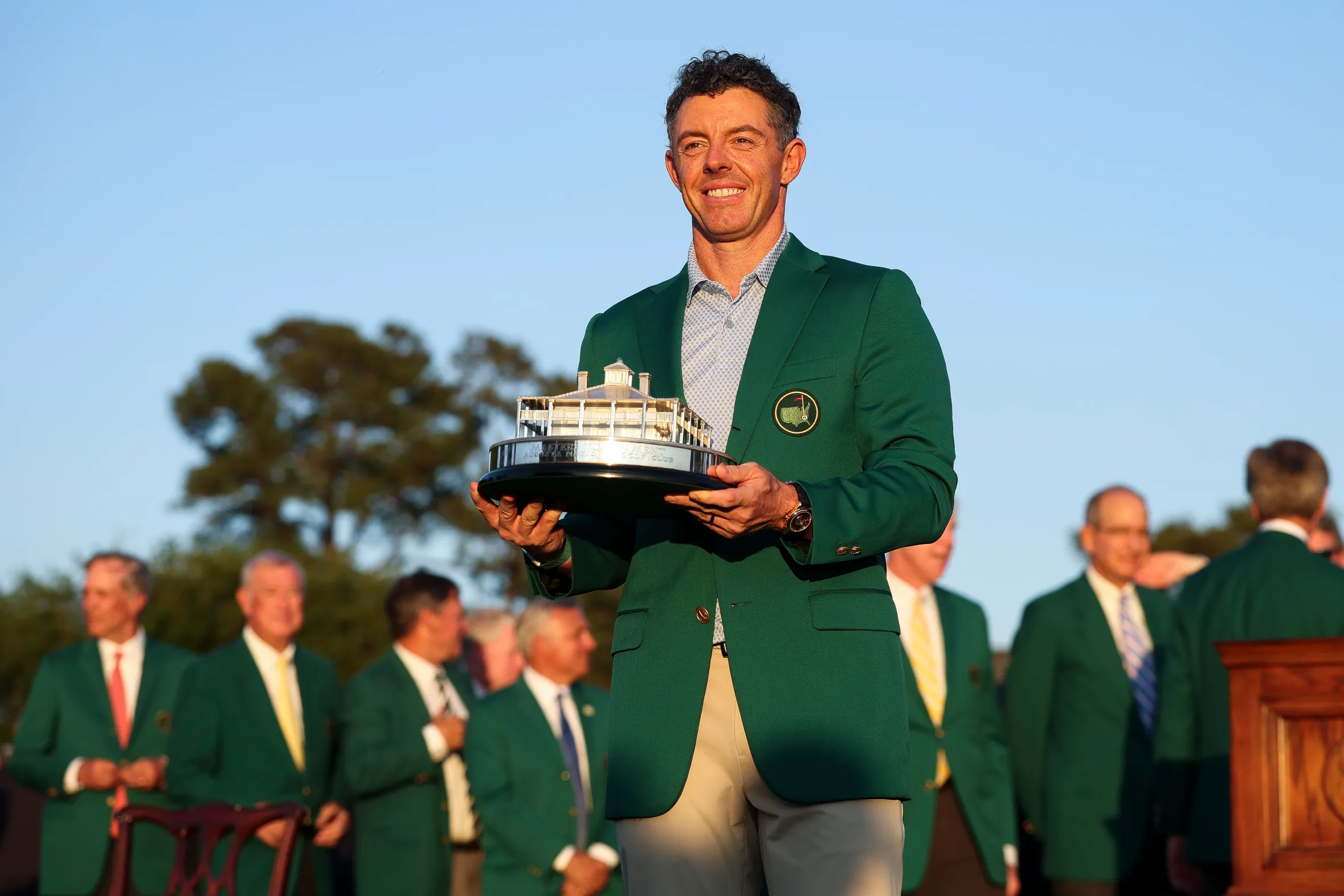 Rory McIlroy in a green jacket holding the Masters Trophy during the Green Jacket Ceremony.