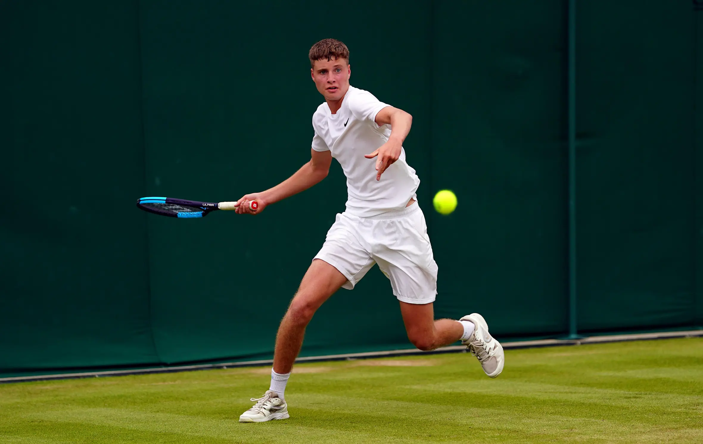 Toby Samuel in action during a Boys singles match at Wimbledon.