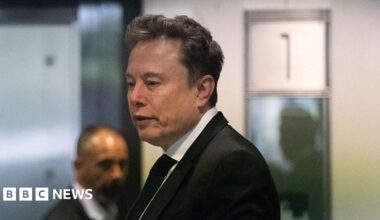 A courtroom sketch of Elon Musk side on sitting down, looking at a tablet screen.
