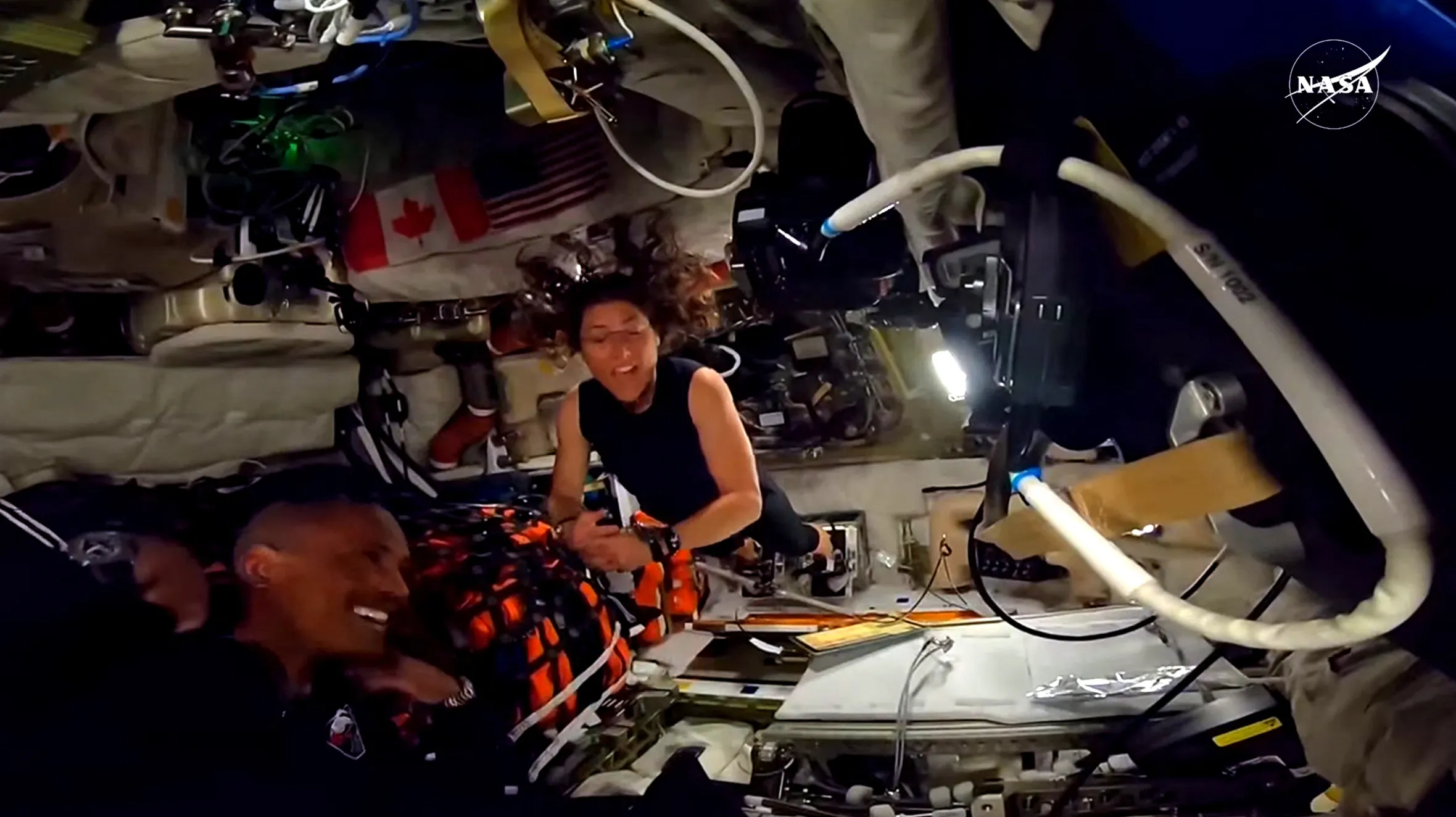 Astronauts Christina Koch and Victor Glover inside the Orion spacecraft during their lunar flyby mission.