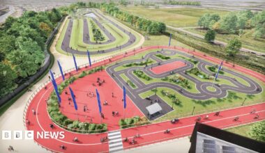 Artist's impression of new hub, with cyclists going around two large red tracks. These are circling a cycle path in the centre, which is set up to look like a road layout.