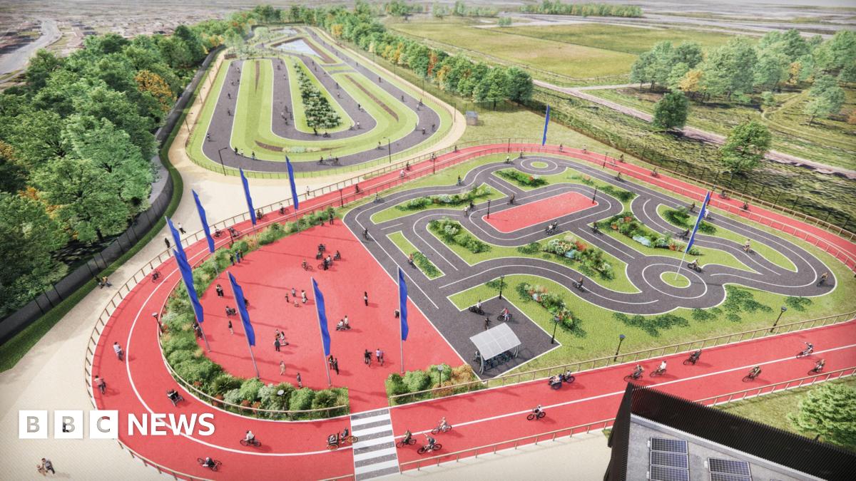 Artist's impression of new hub, with cyclists going around two large red tracks. These are circling a cycle path in the centre, which is set up to look like a road layout.