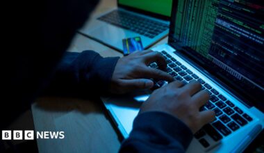 Man sitting with his hands on the keyboard of a laptop
