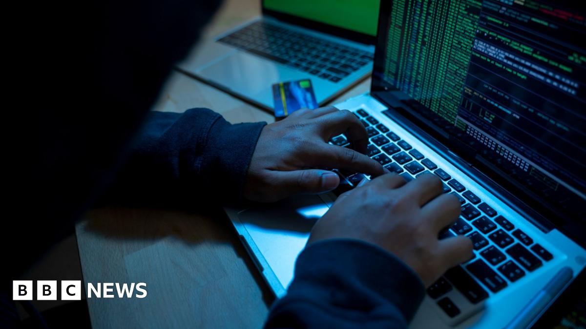 Man sitting with his hands on the keyboard of a laptop
