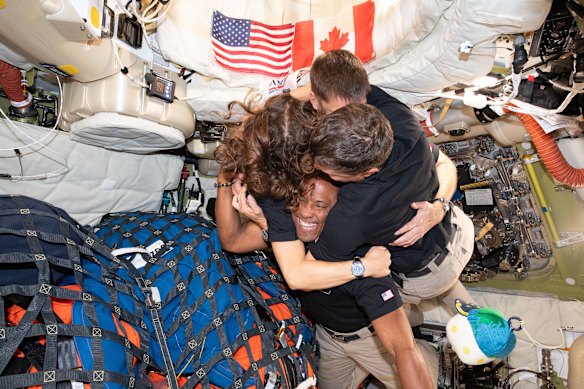 A group hug on the astronauts’ way home on Wednesday.