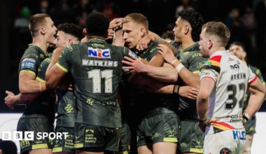 James McDonnell of Leeds celebrates with team-mates after scoring a try