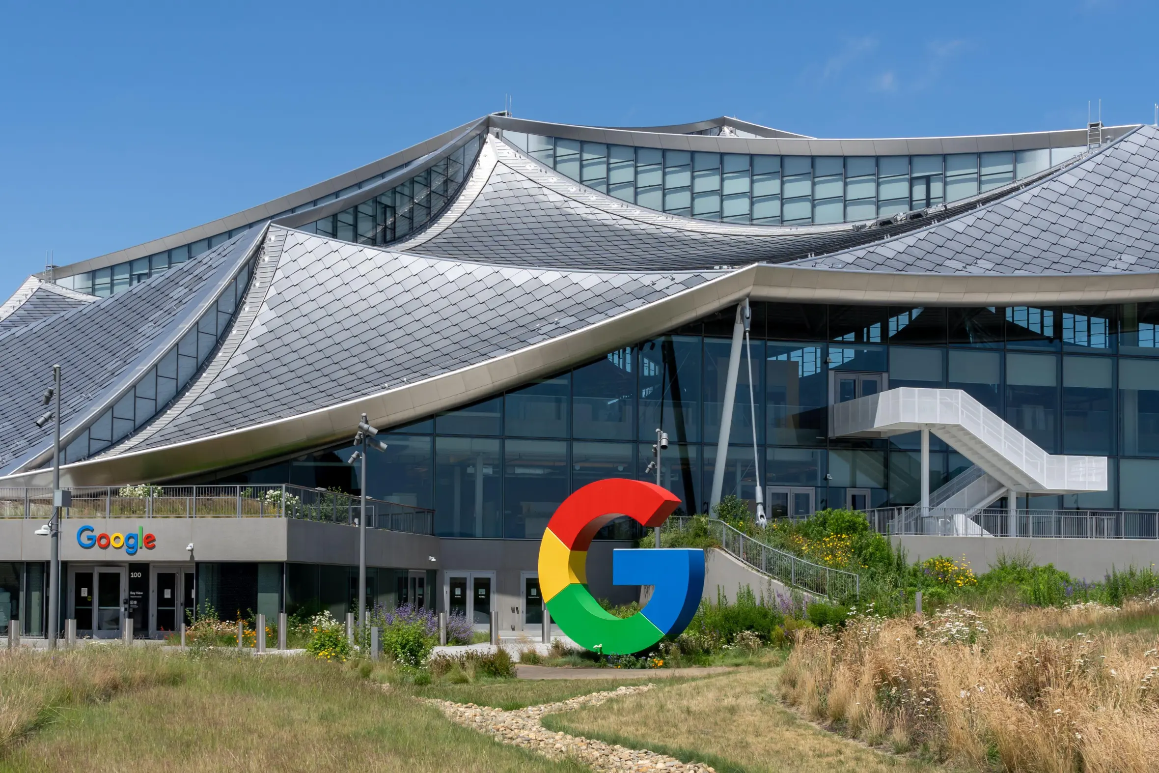 The Google Bay View corporate campus in Mountain View, California, USA, featuring the colorful Google "G" logo in the foreground.