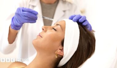 A stock image of a female patient receiving cosmetic treatment