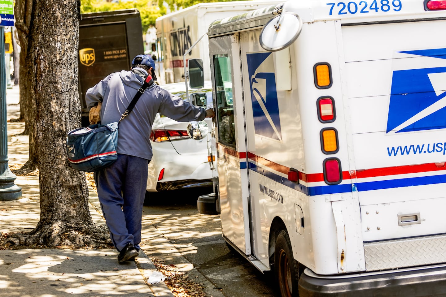 US Postal Service worker makes delivery in Miami.