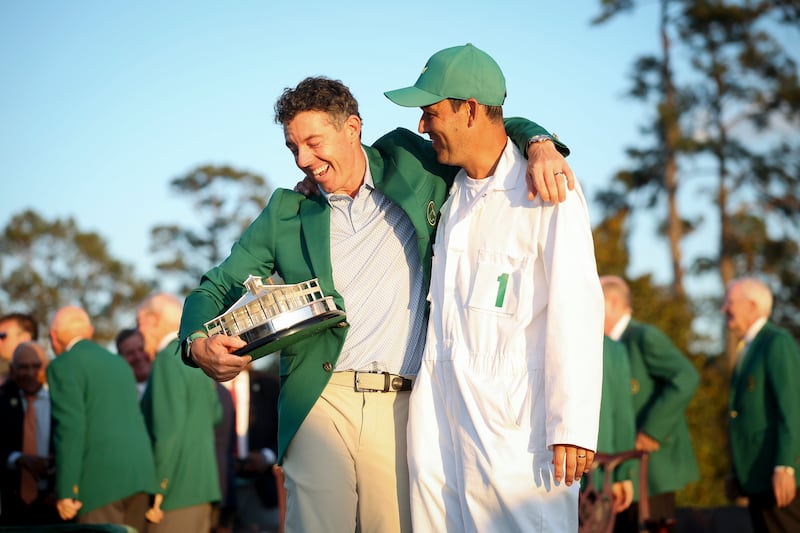 Rory McIlroy celebrates with his caddie and close confidant Harry Diamond and the Masters trophy in Augusta, Georgia. Photograph: Hector Vivas/Getty Images