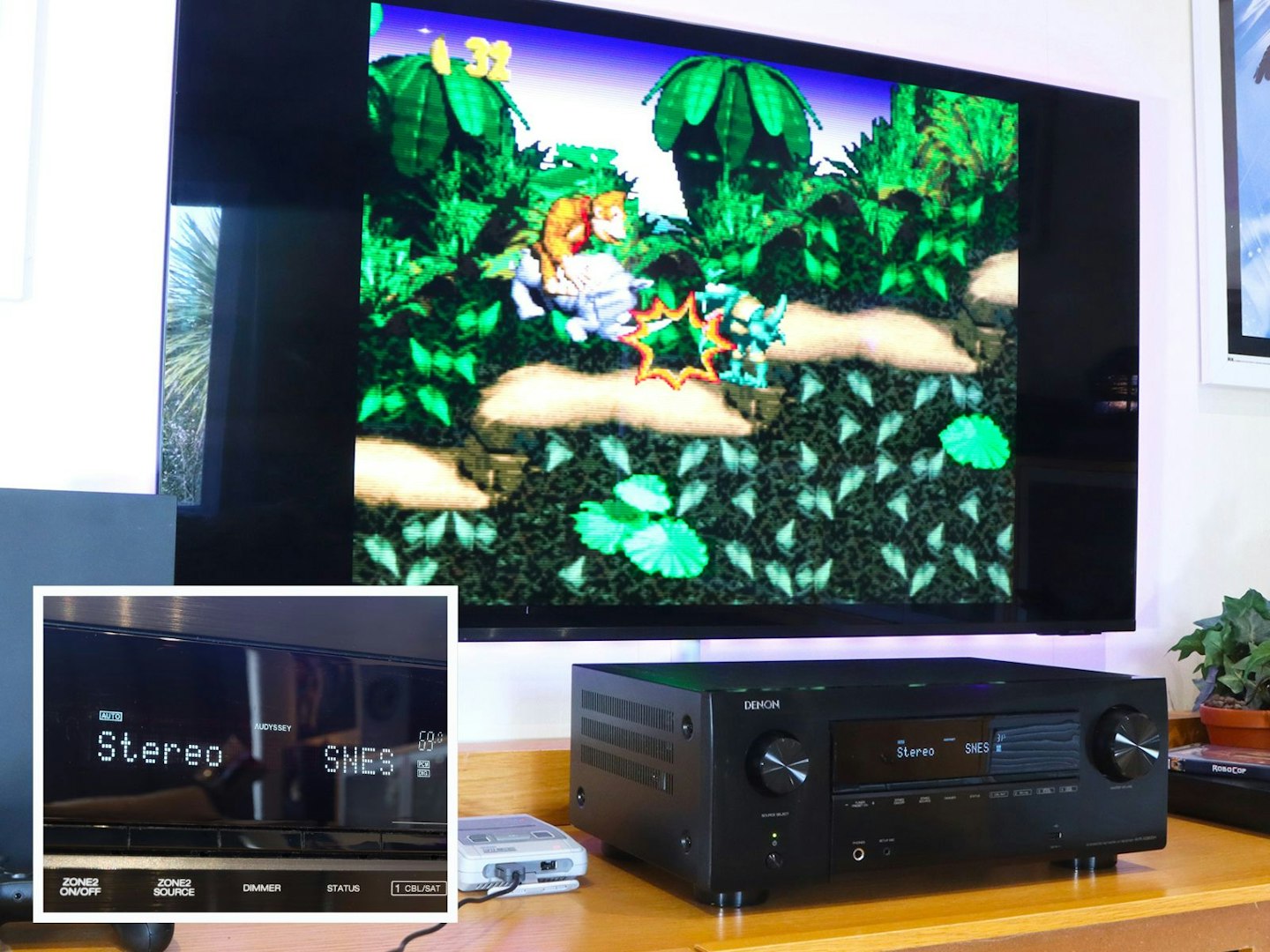 Denon AVR-X2800H Home Cinema Amplifier on a stand with SNES console in front of a TV showing Donkey Kong Country