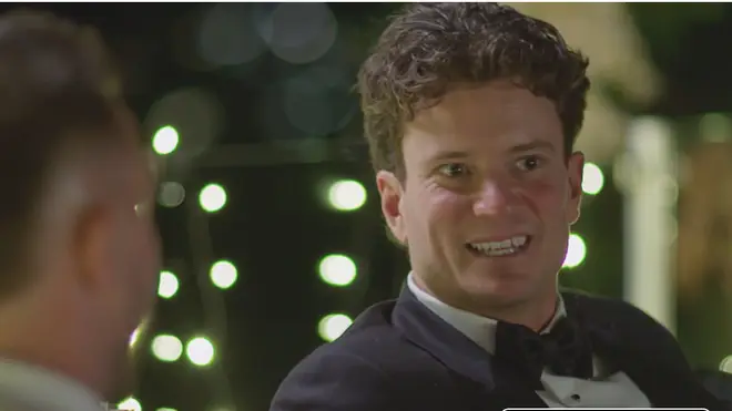 Sam and Chris pictured talking at their reception.