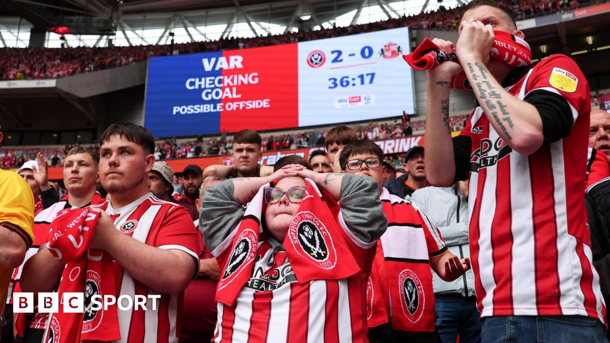 Dozens of Sheffield United fans, mostly dressed in red and white club shirts, look on in anguish in the lower tier behind the goal at Wembley Stadium during the Championship play-off final moments before their second goal against Sunderland was disallowed by VAR for offside.