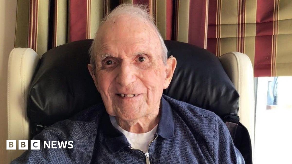 Rosemary Agnew, a woman with short grey hear, wearing a black top and pearl earrings and necklace.