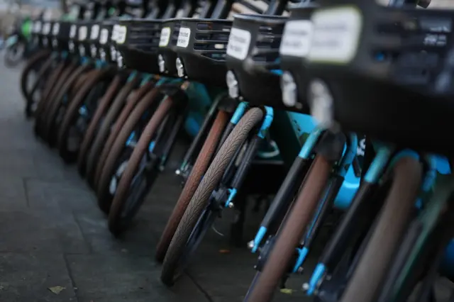 The front wheels of numerous Forest bike next to each other