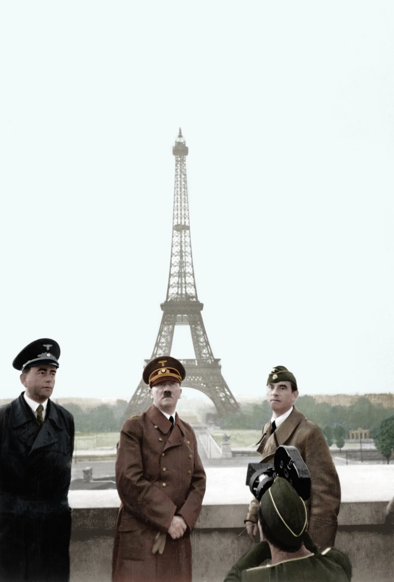 Adolf Hitler, Albert Speer, and Arno Breker pose in front of the Eiffel Tower in Paris.