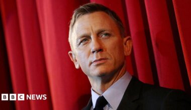 Daniel Craig pictured on the red carpet for the James Bond film Spectre; he is wearing a black suit.