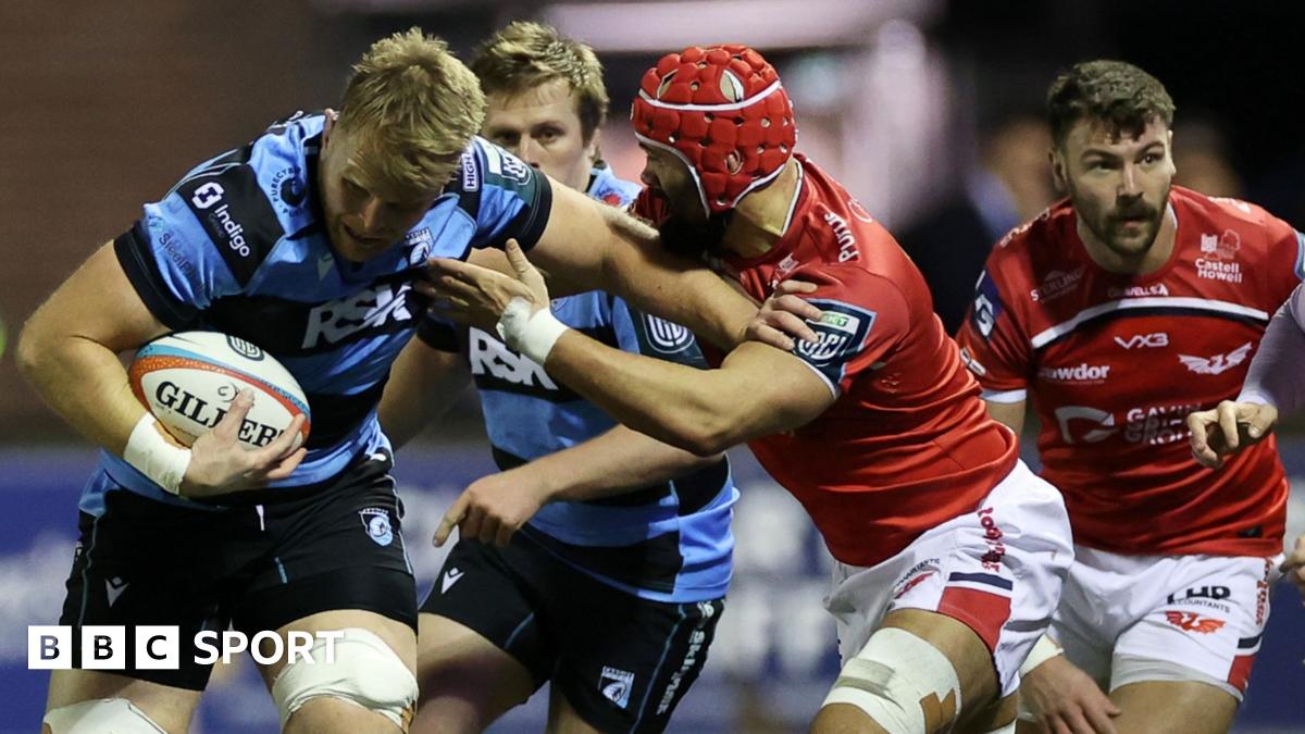 Josh McNally of Cardiff is tackled by Josh Macleod of Scarlets