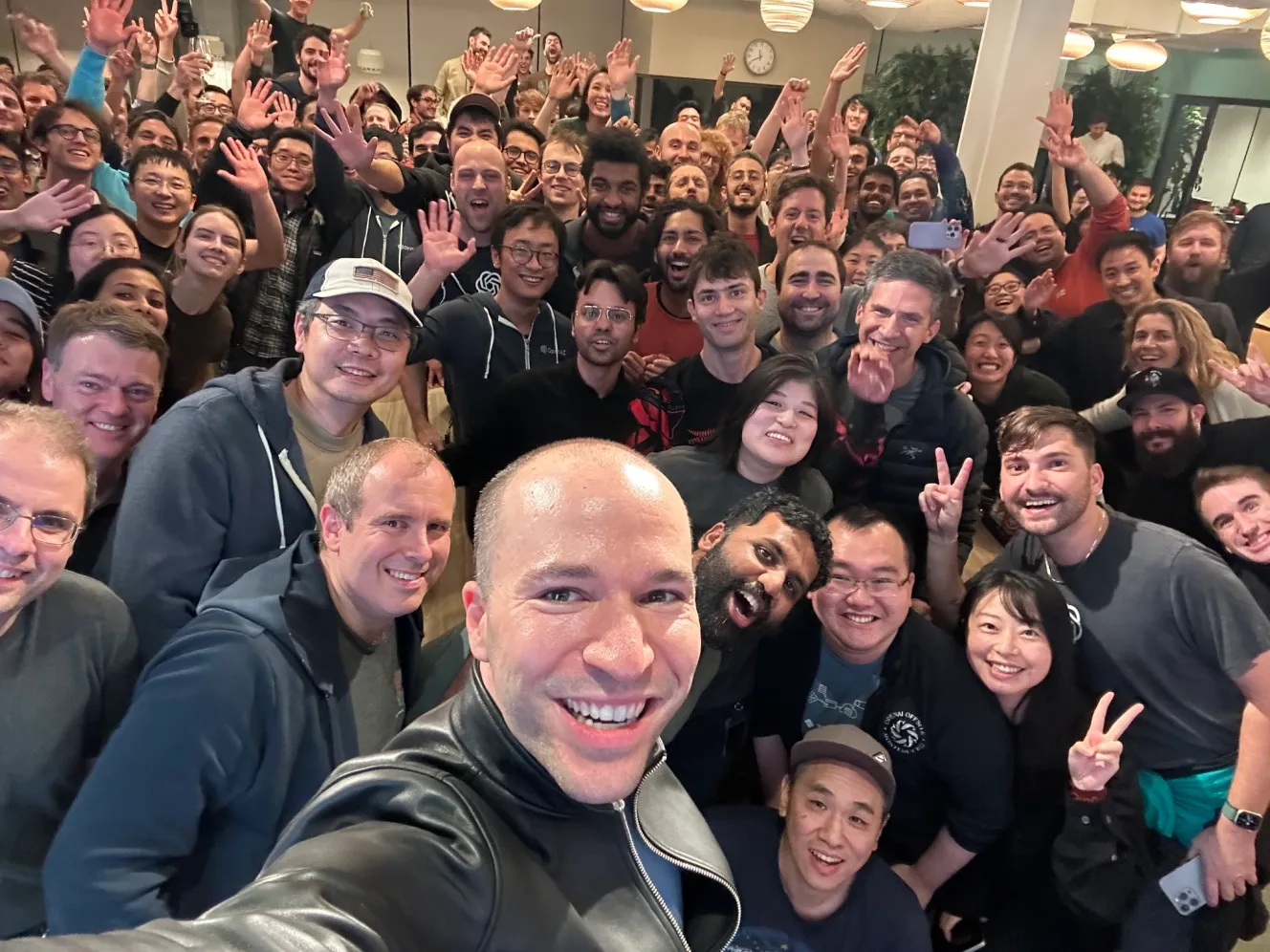 Greg Brockman with OpenAI team members after his return to the company.