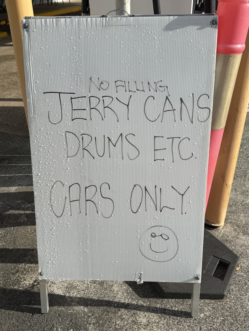A sign saying 'No filling jerry cans, drums etc. Cars only'.