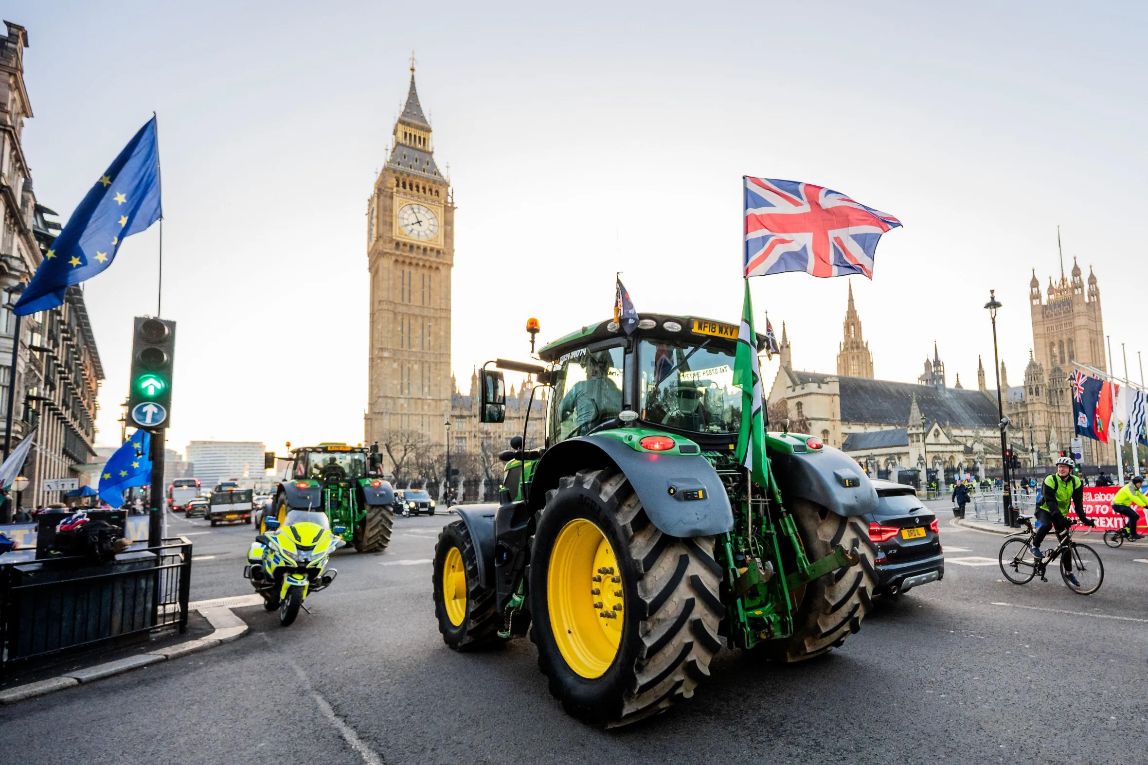 Tractors with UK flags near Big Ben during a farmer's protest.