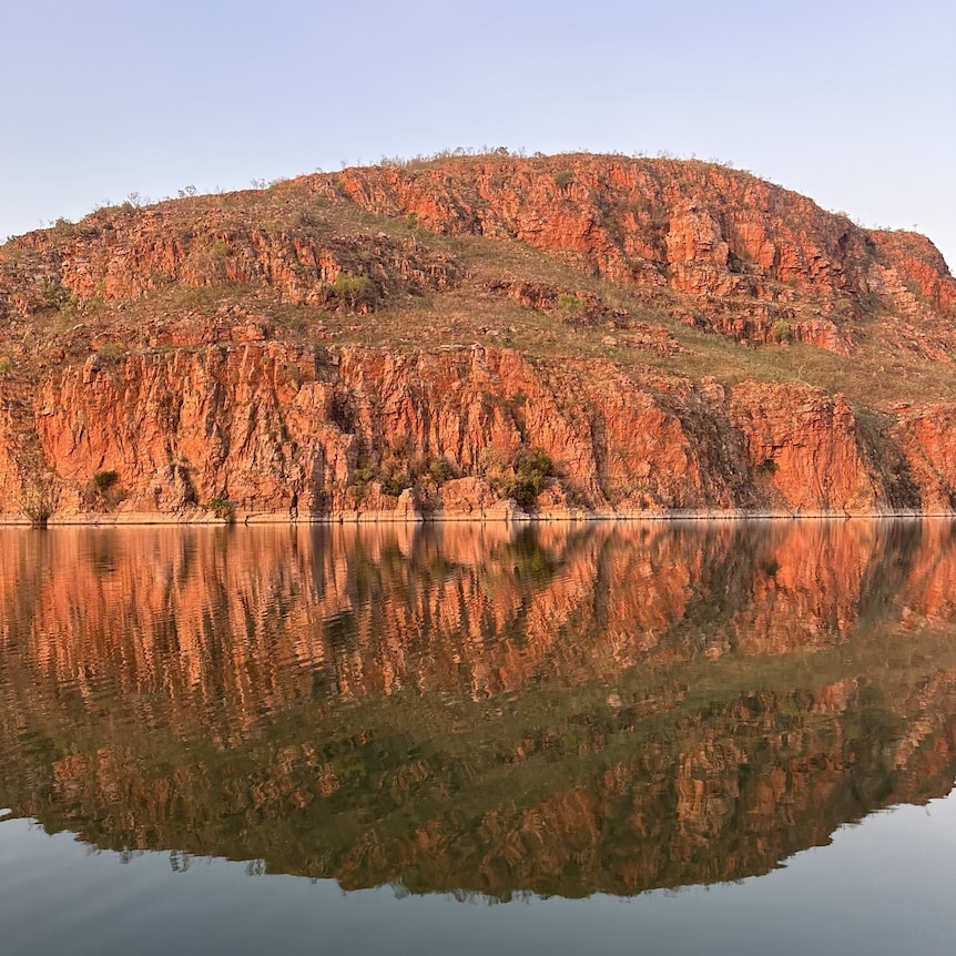 rugged red cliffs and a river