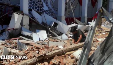 A resident inspects the damage at a sports complex in Manado