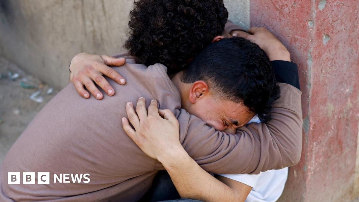 Two Palestinians mourn after the Israeli military carried out strikes during clashes between Hamas security personnel and Israeli-backed militiamen, at al-Aqsa hospital in Deir al-Balah, central Gaza (6 April 2026)