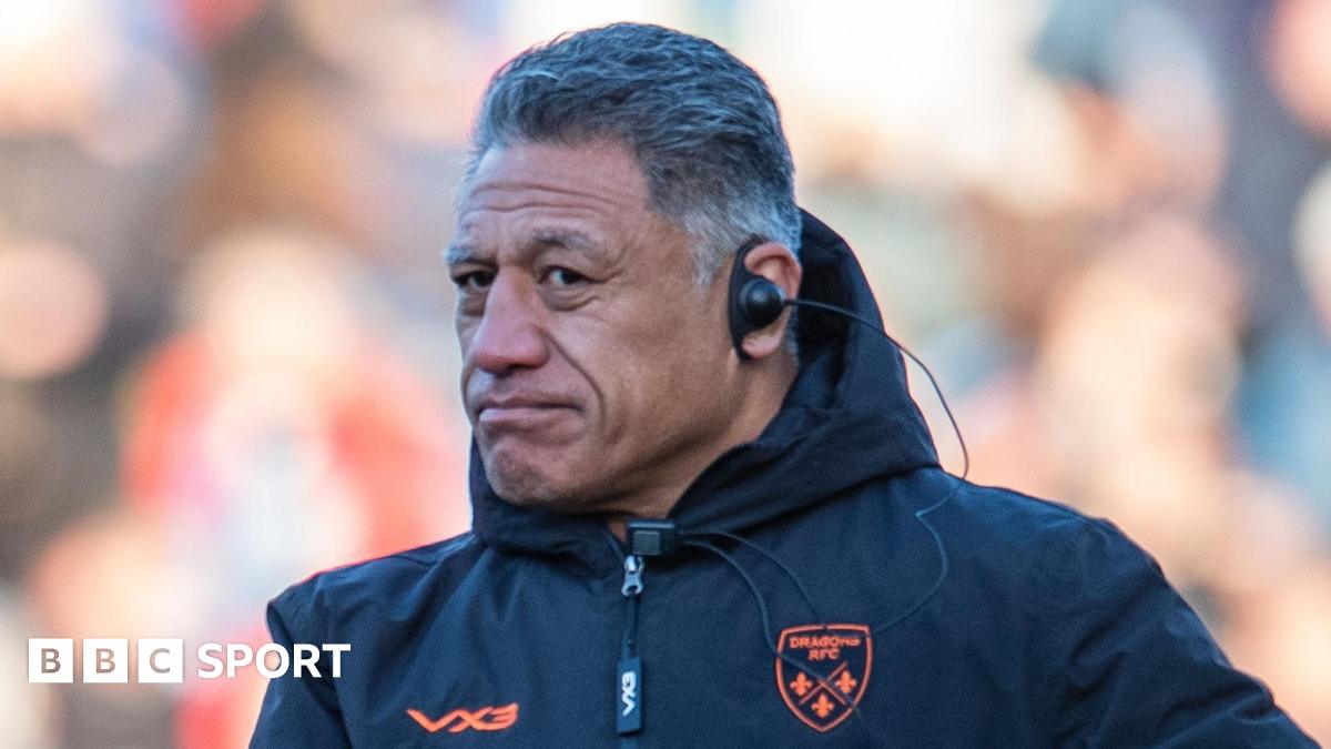 Head coach Filo Tiatia on the touchline in a blue Dragons coats wearing an earpiece.