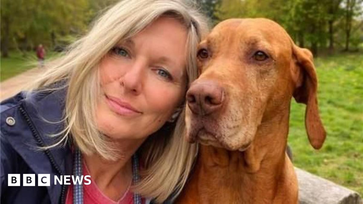 Harvey Cooper wearing a dark t-shirt standing in front of grass and trees