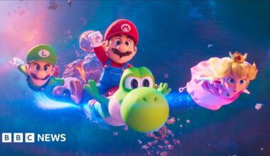 Cartoon characters Mario, Luigi, Princess Peach and Yoshi are flying through the sky towards the camera. Luigi is wearing a green cap with a white L and green long sleeved top and overalls, he has a mustache and blue eyes. Mario is wearing the same but in red, with an M on his cap. He is riding Yoshi; a cartoon green dinosaur with a red shell and large round nose. Peach is blond and is wearing a gold crown with a pink gown on.