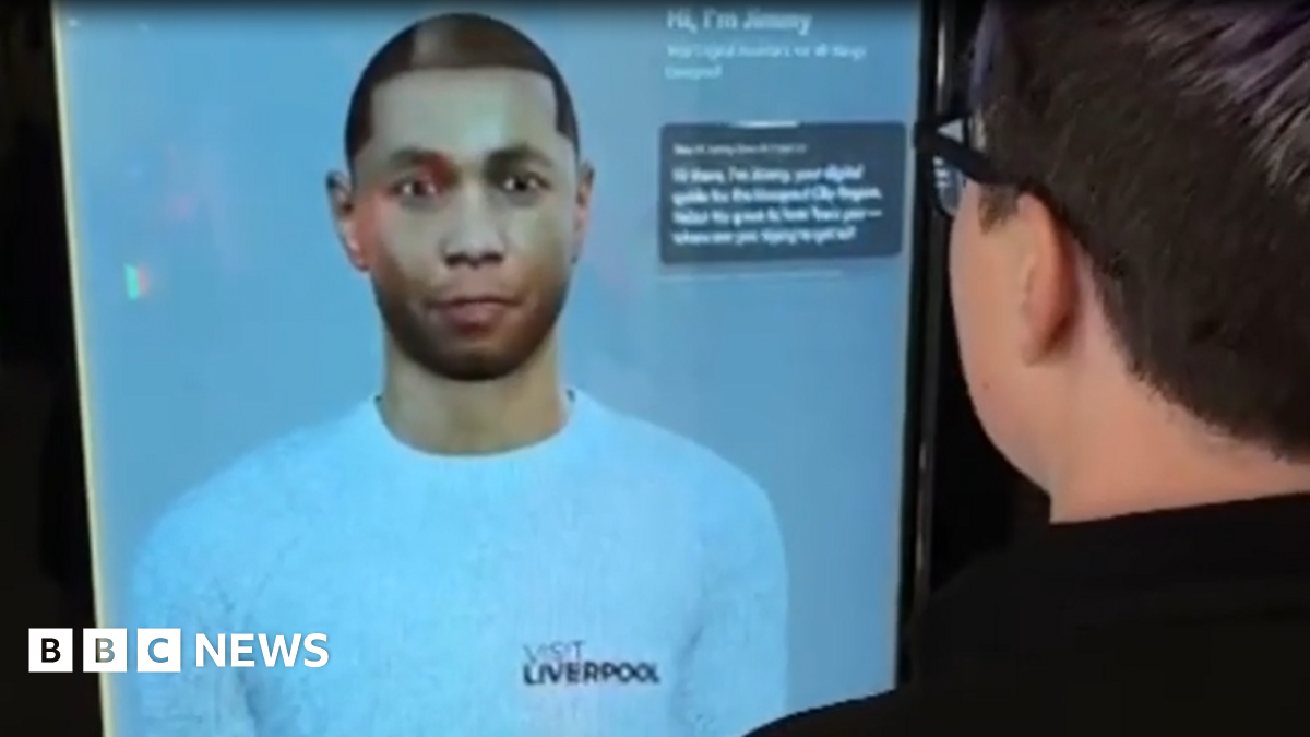 A digital depiction of a young man wearing a white top with the Visit Liverpool logo on a large screen with some text captions in the top right corner. A man with glasses can be seen on the right using the service on screen.