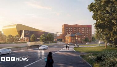 A computer-generated artist's impression of a hotel. A dual carriageway has a steady stream of cars on it while people walk along a path next to it. Across the road is a brown seven-storey building which says "Moxy" in pink lettering. Next to it is a stadium with a yellow building behind it with lettering that reads "Connexin Live".