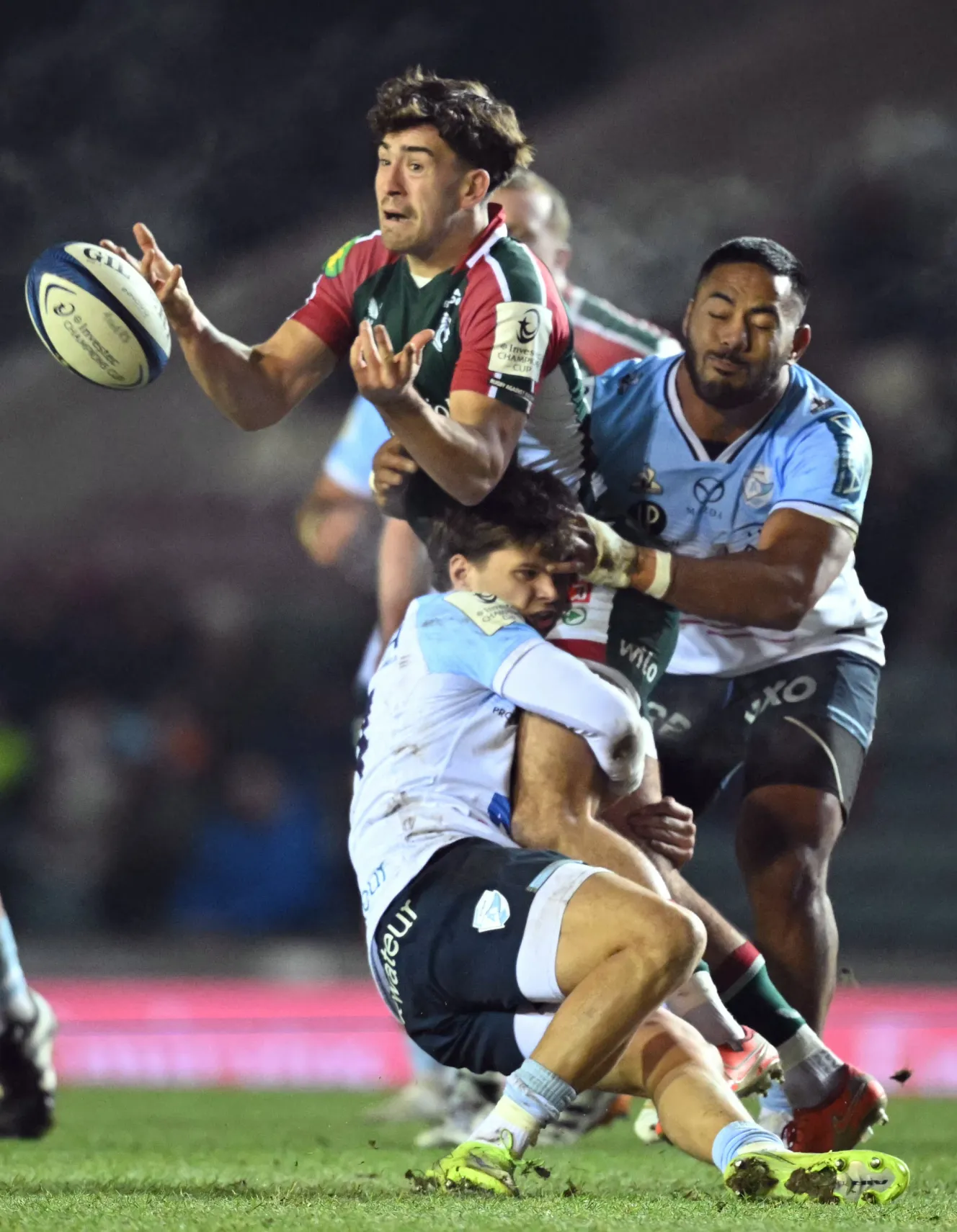 Leicester's Orlando Bailey is tackled by Bayonne's Gabriel Lapegue and Manu Tuilagi during a rugby match.