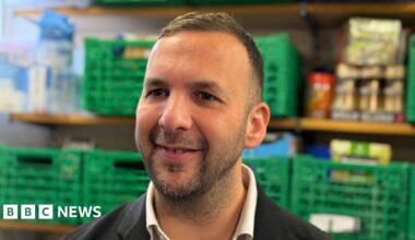 Green Party Leader Zack Polanski, a man in his early forties in a dark suit with dark hair, dark eyes and stubble