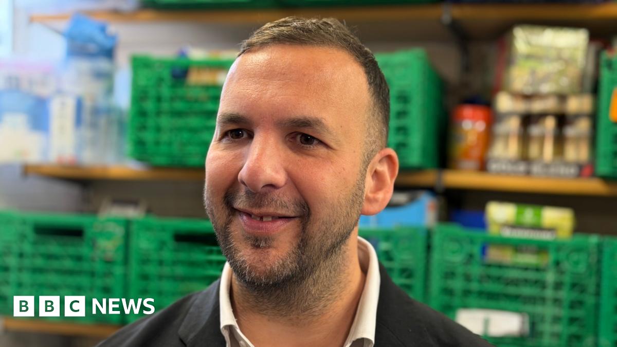 Green Party Leader Zack Polanski, a man in his early forties in a dark suit with dark hair, dark eyes and stubble