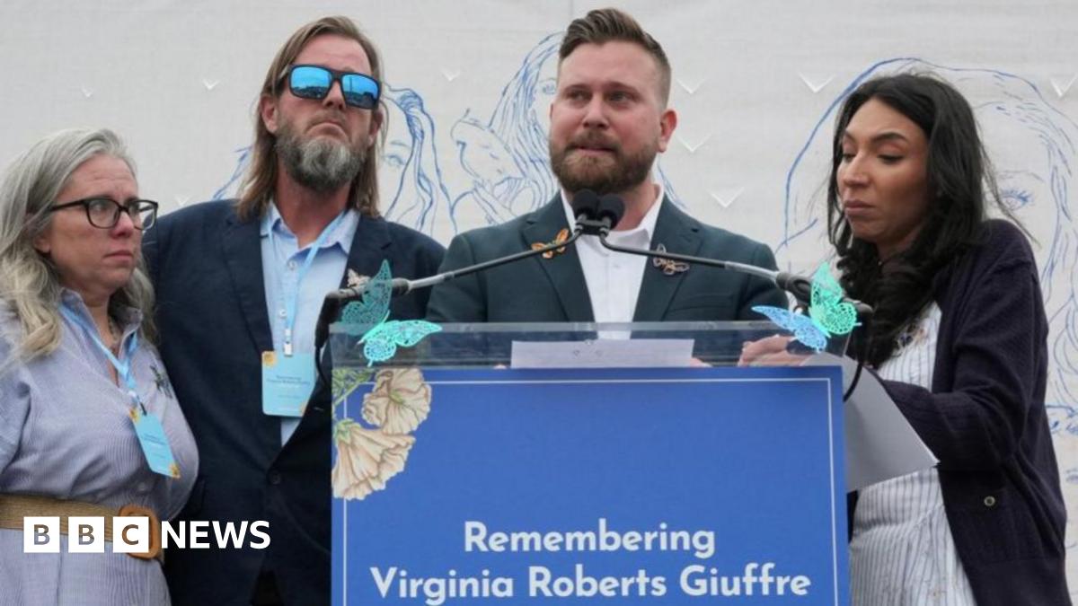 Virginia Giuffre's brothers, Sky Roberts (second right) and Danny Wilson, and her sisters-in-law, Lanette Wilson (on left) and Amanda Roberts, stand together during a "butterfly" vigil commemorating the one-year anniversary of the death of Virginia Roberts Giuffre.