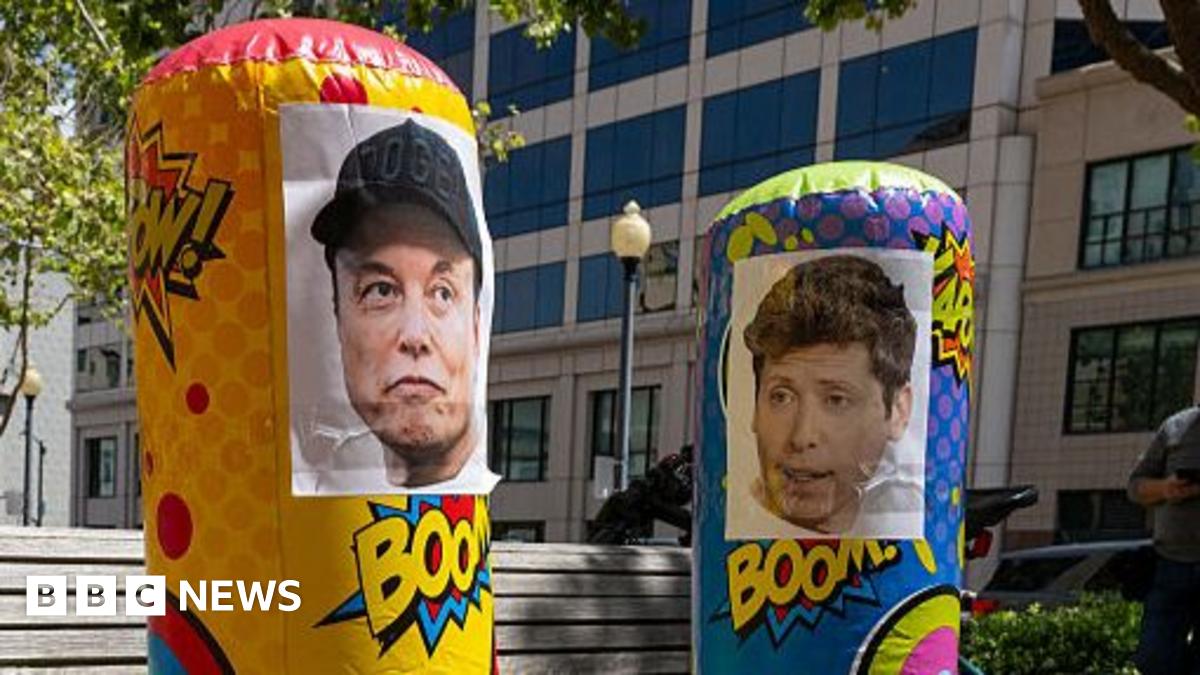 Punching bags with the faces of Musk and Altman seen outside of court
