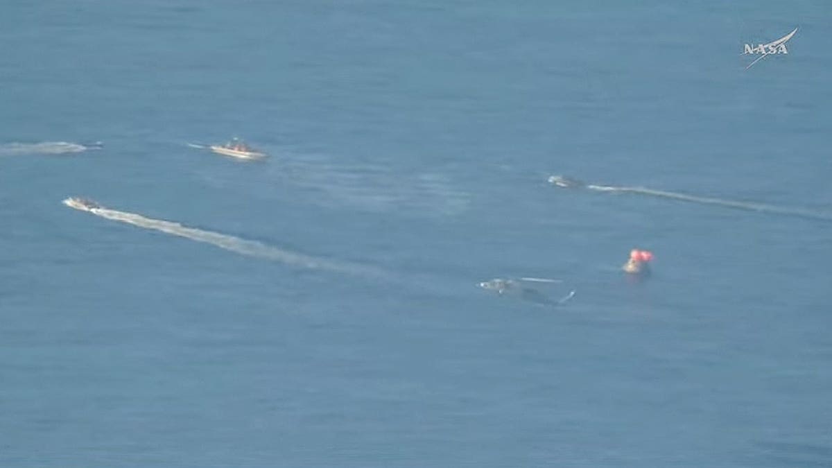 Recovery forces approach Artemis II after its splashdown off the coast of San Diego on Friday, April 10, 2026. (NASA)