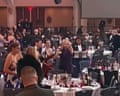 Guests take bottles from a table in the aftermath of the White House press dinner shooting – video