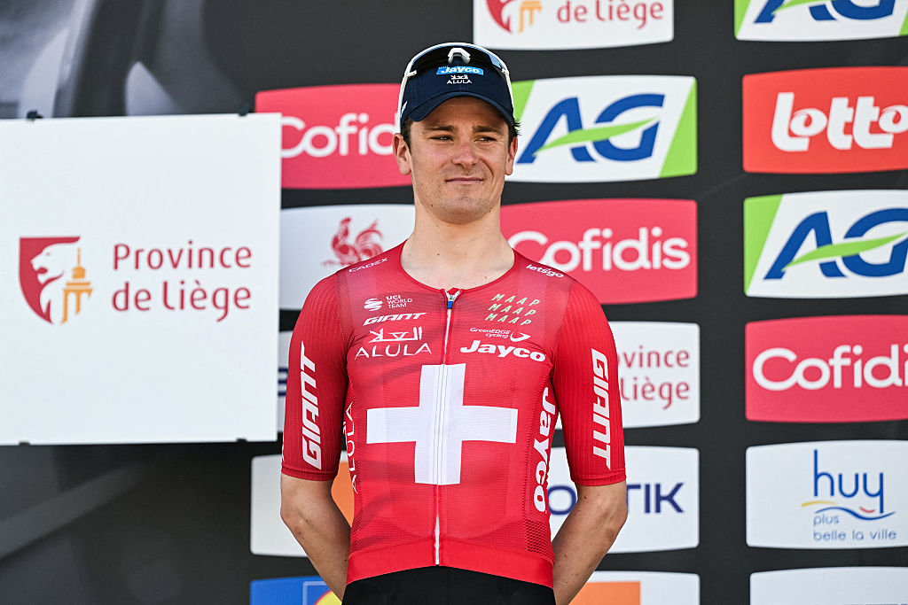 Mauro Schmid stands on the podium, smiling, after finishing second in La Fl&egrave;che Wallonne