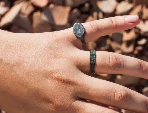 Close Up Of Two Excavated Rings, One Bearing Visible Engraved Script