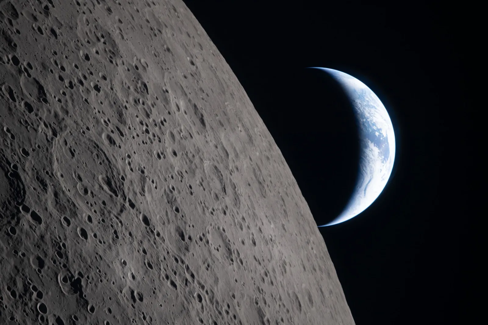 The Artemis II crew captured this view as the Earth sets behind the moon during a lunar flyby on April 6, 2026