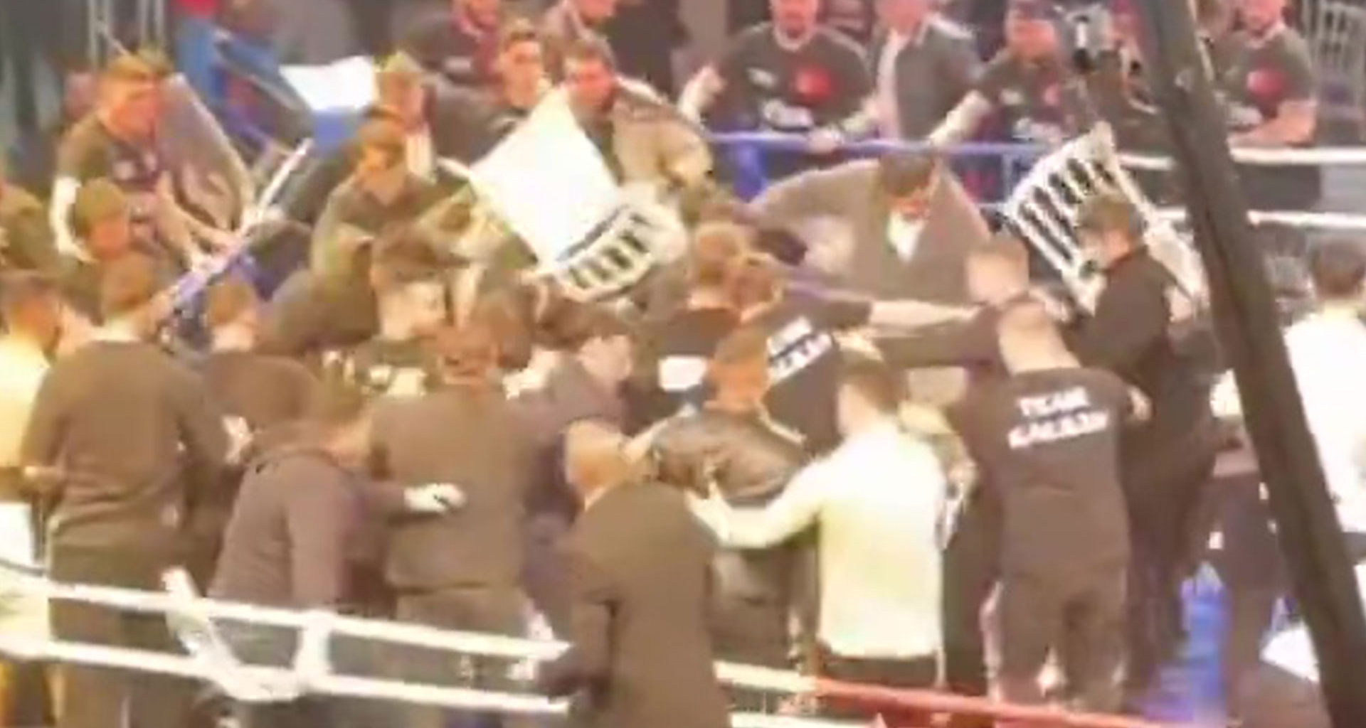 Crowd storm the ring to attack boxer as over 40 people throw chairs and punches in mass brawl