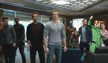 The Avengers standing in a room looking nervous with a yelling Robert Downey Jr. in a green suit photoshopped in