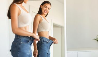 Excited Young Fit Woman Weight Loss Jeans