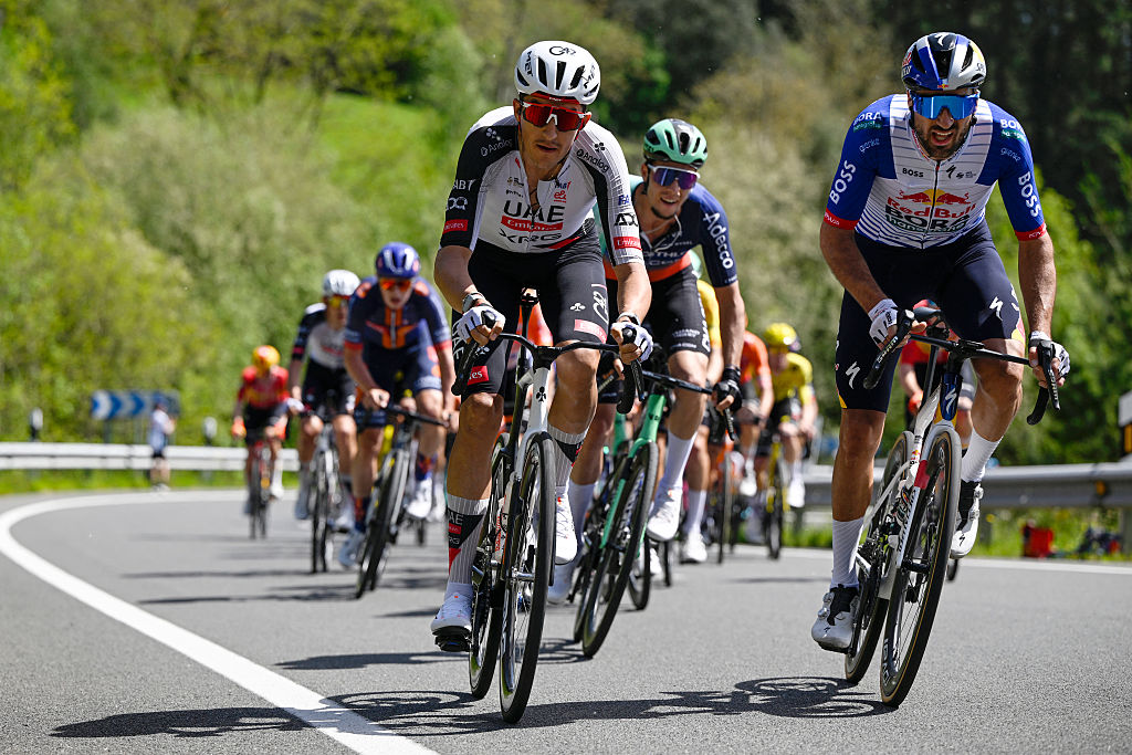 Cyclists in the pack ride in Llodio during the third stage of the Basque Country's Itzulia cycling tour, a 152.8 km race starting and finishing in Basauri, on April 8, 2026. (Photo by ANDER GILLENEA / AFP)