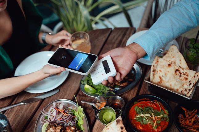 Making contactless payment with smartphone at restaurant