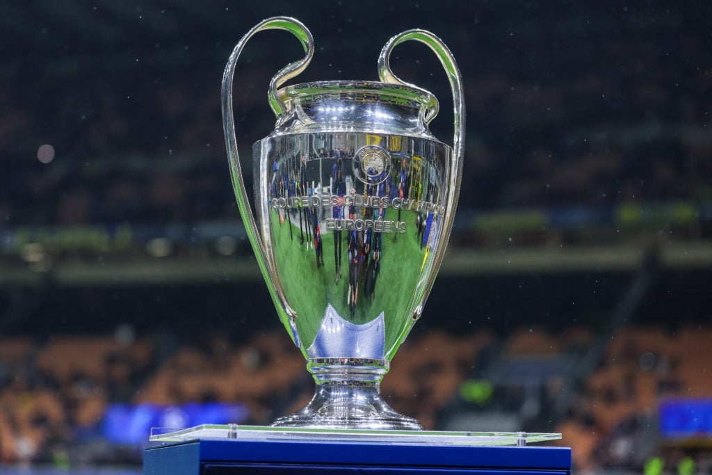 The UEFA Champions League trophy is displayed on a plinth at